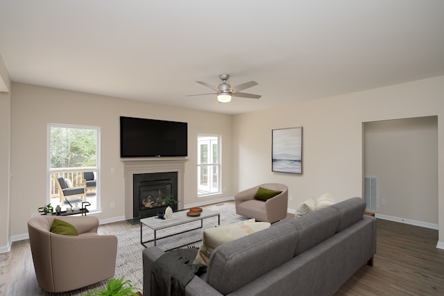 living room featuring wood-type flooring and ceiling fan