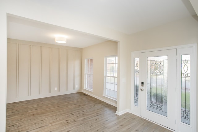 foyer entrance with light hardwood / wood-style floors