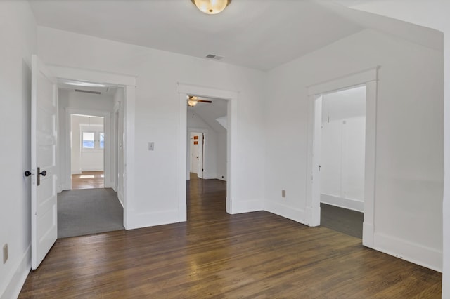 empty room with dark wood-type flooring and ceiling fan