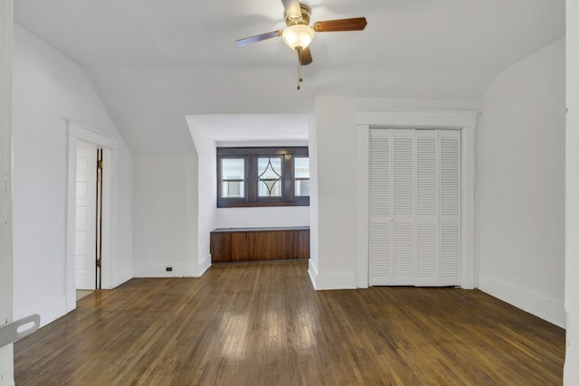 interior space with lofted ceiling, dark hardwood / wood-style floors, and ceiling fan