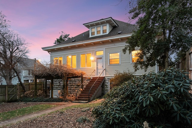 view of back house at dusk