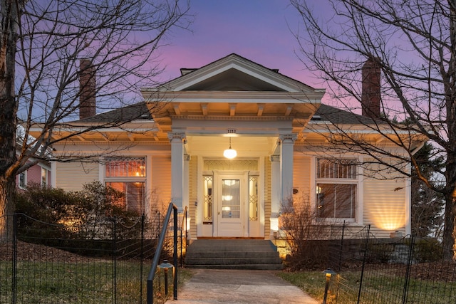 view of exterior entry at dusk