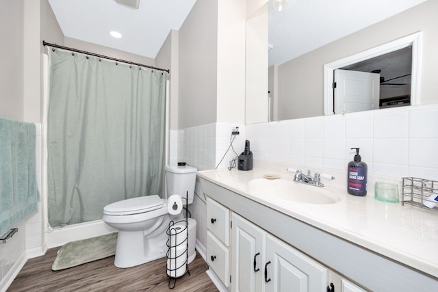 bathroom with hardwood / wood-style floors, vanity, toilet, and a shower with curtain