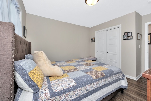 bedroom with dark wood-type flooring and a closet