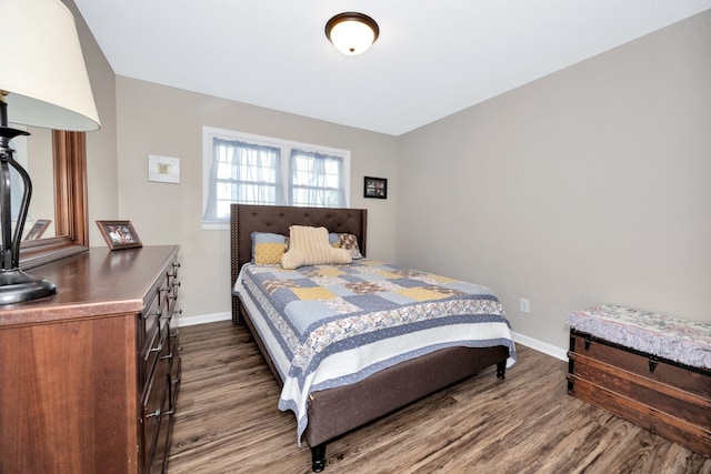 bedroom with dark hardwood / wood-style flooring