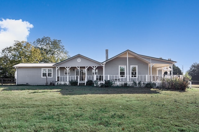 rear view of property featuring a porch and a lawn