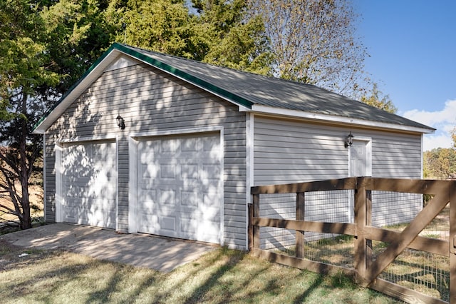 view of side of home featuring a garage and an outdoor structure