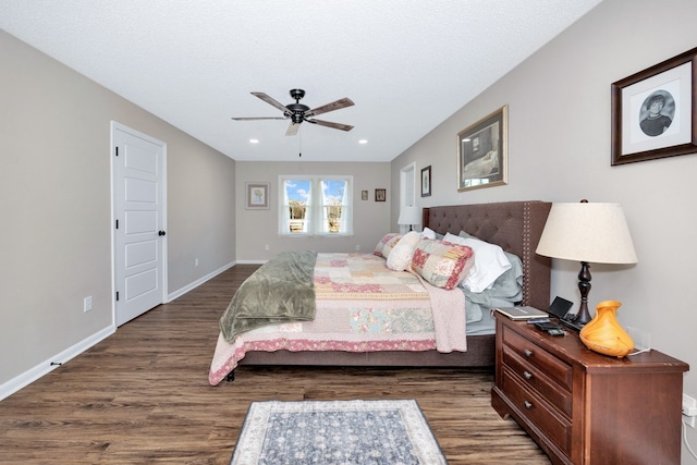 bedroom featuring dark hardwood / wood-style flooring and ceiling fan