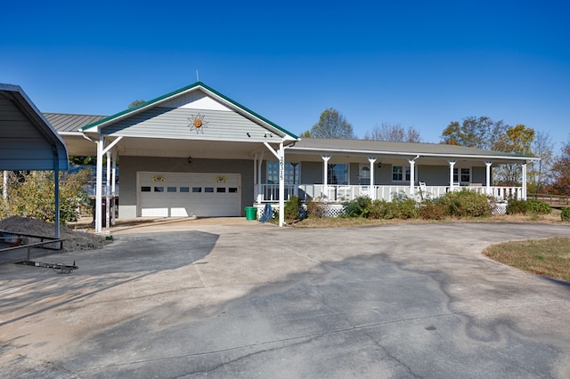 view of front of house with a garage, covered porch, and a carport