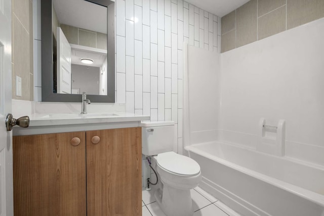 full bathroom with shower / tub combination, vanity, tile patterned floors, toilet, and tile walls