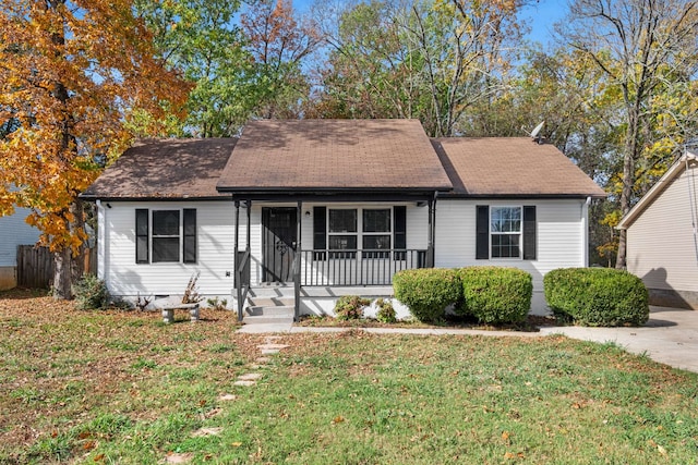 view of front of property with a front yard and covered porch