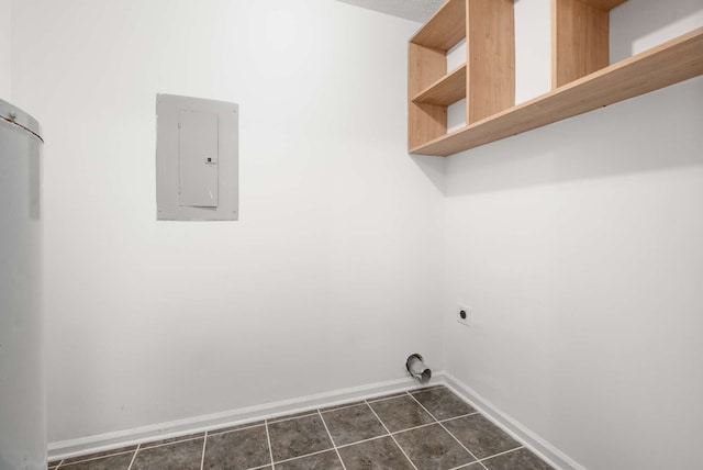 laundry room featuring hookup for an electric dryer, electric panel, and dark tile patterned floors