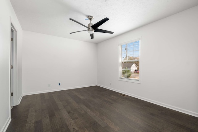 unfurnished room with dark wood-type flooring, a textured ceiling, and ceiling fan