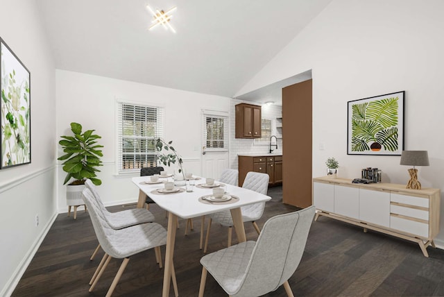 dining area with high vaulted ceiling, dark hardwood / wood-style floors, and sink