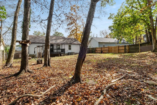 view of yard with a wooden deck and central AC