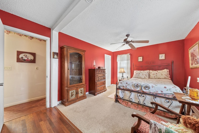 bedroom featuring a textured ceiling, hardwood / wood-style flooring, and ceiling fan