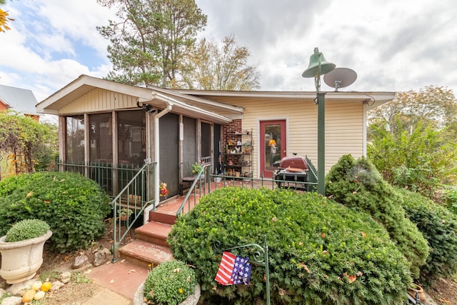 view of front of home featuring a sunroom