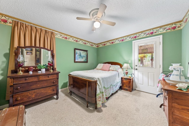 carpeted bedroom with a textured ceiling and ceiling fan