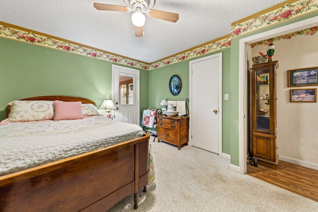 bedroom featuring carpet, a textured ceiling, and ceiling fan