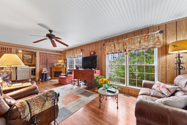 living room featuring ceiling fan, washer and dryer, light hardwood / wood-style floors, and plenty of natural light