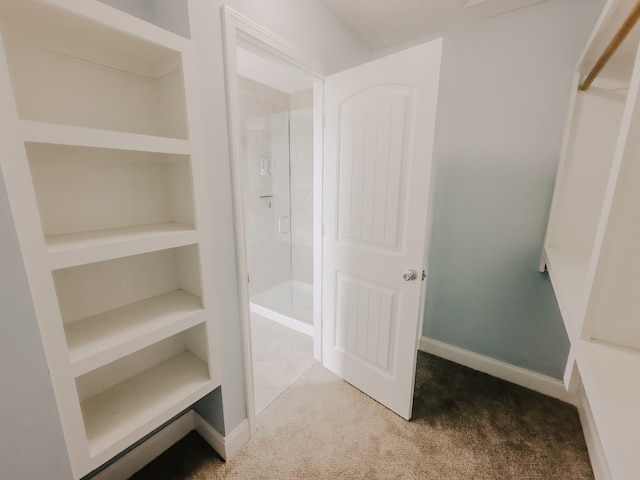 walk in closet with carpet floors