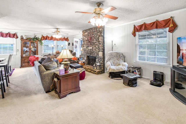 living room with a textured ceiling, carpet floors, crown molding, and a healthy amount of sunlight