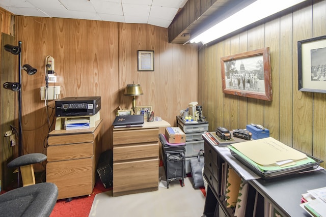 office with wood walls and carpet floors