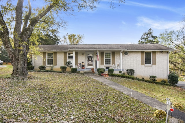 single story home with a front lawn and a porch