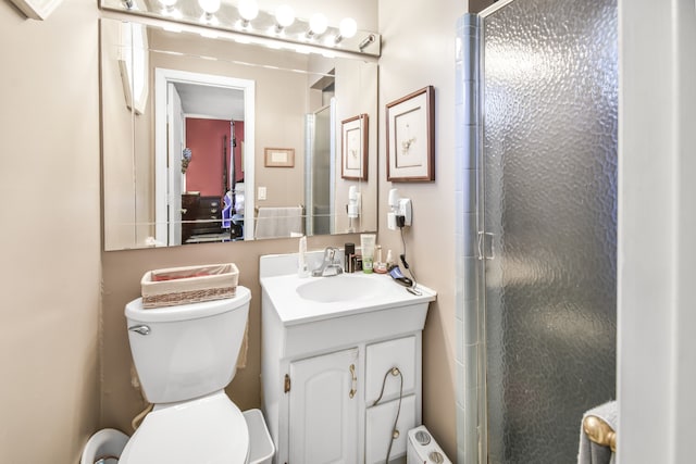 bathroom featuring vanity, toilet, and an enclosed shower