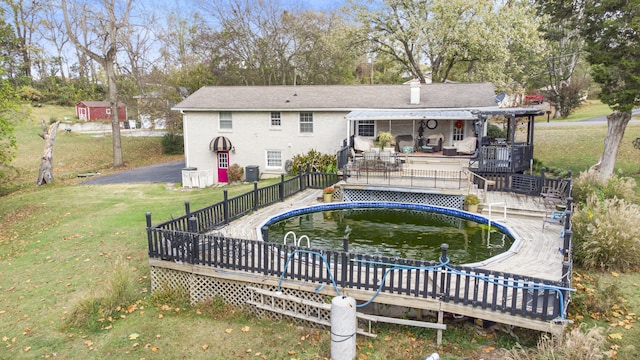 view of pool with a yard, cooling unit, and a deck