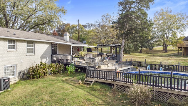 view of yard with a pergola, central AC, and a deck