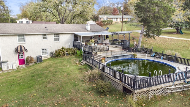 back of house featuring a yard and central AC unit