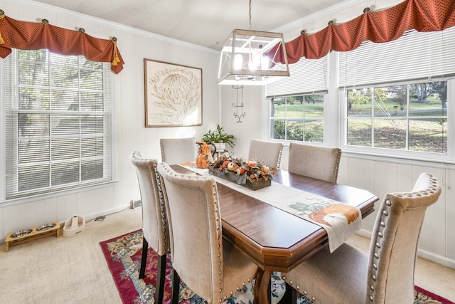 dining room featuring carpet, plenty of natural light, and ornamental molding