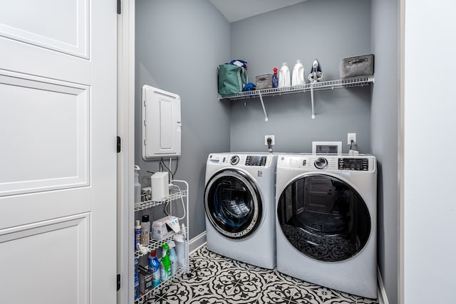 washroom with washer and clothes dryer, electric panel, and light tile patterned floors