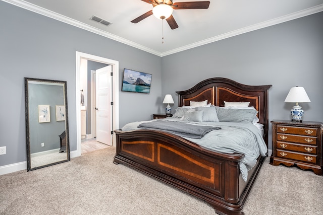 bedroom with light carpet, ceiling fan, crown molding, and connected bathroom