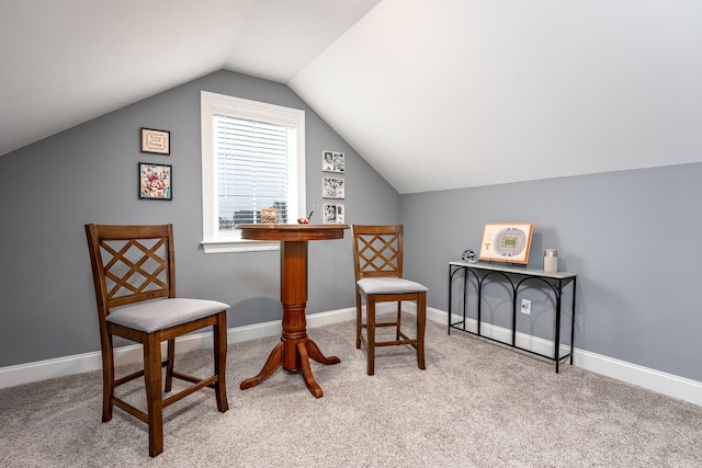 sitting room featuring lofted ceiling and light carpet