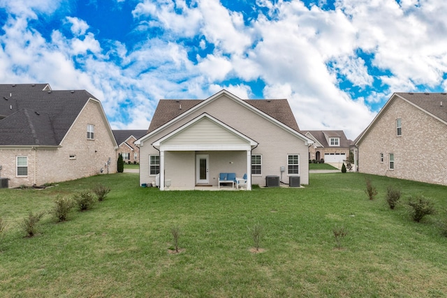 back of house with a lawn and a patio