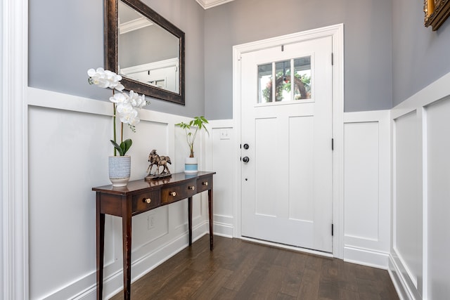 entryway with crown molding and dark hardwood / wood-style flooring