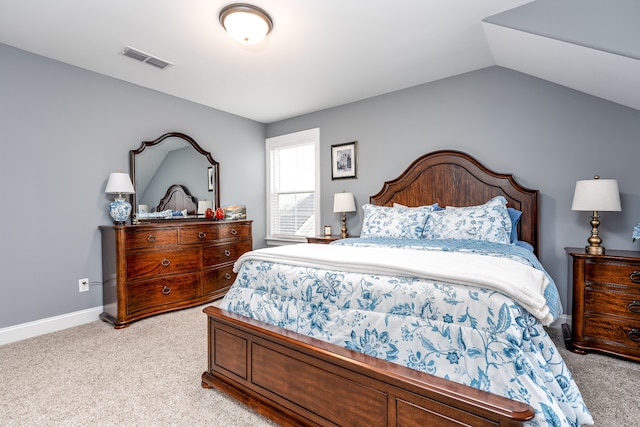 bedroom featuring vaulted ceiling and light carpet