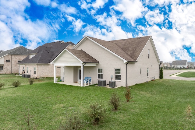 rear view of house featuring a yard and a patio area