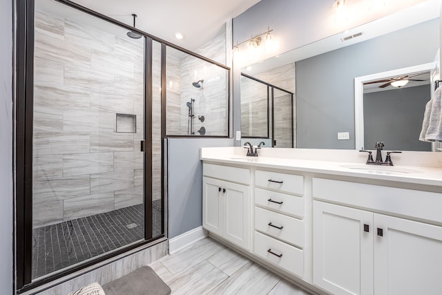 bathroom with walk in shower, vanity, and ceiling fan