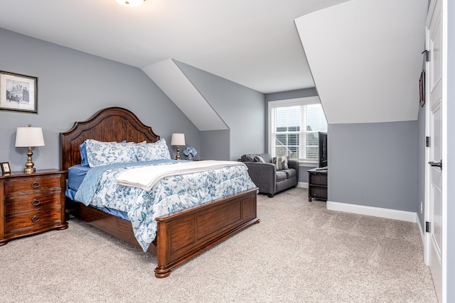 carpeted bedroom featuring vaulted ceiling