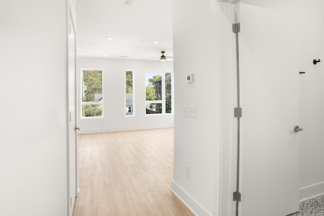 hallway with light hardwood / wood-style flooring