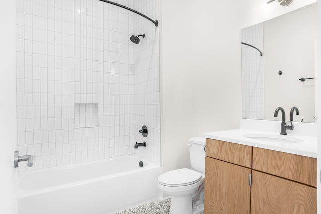 full bathroom featuring toilet, tiled shower / bath combo, and vanity