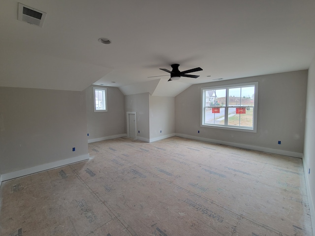 additional living space featuring ceiling fan and vaulted ceiling