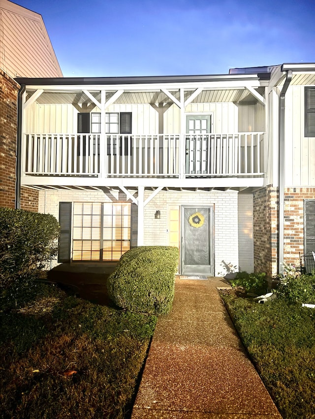 back of house featuring a balcony