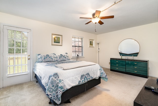 carpeted bedroom featuring ceiling fan and multiple windows