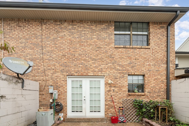 rear view of house with french doors and cooling unit