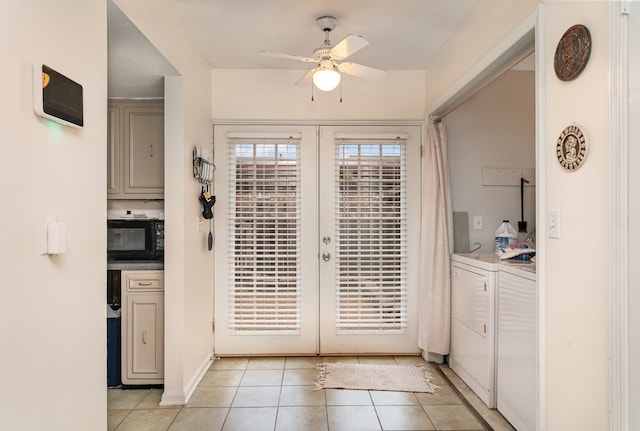 entryway featuring washing machine and dryer, ceiling fan, light tile patterned floors, and french doors