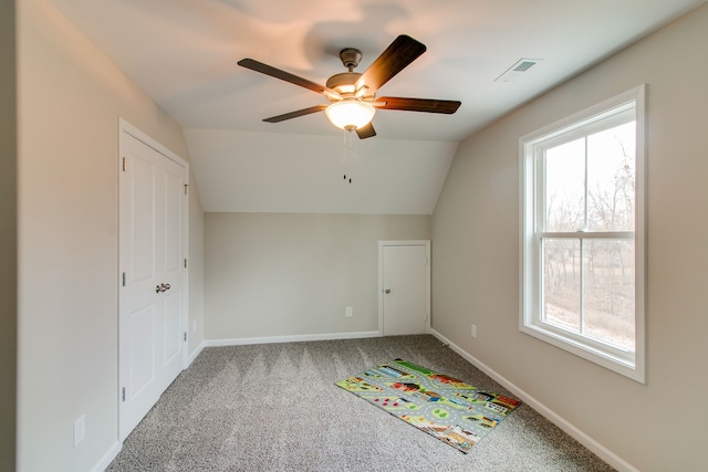 additional living space featuring ceiling fan, carpet, and lofted ceiling